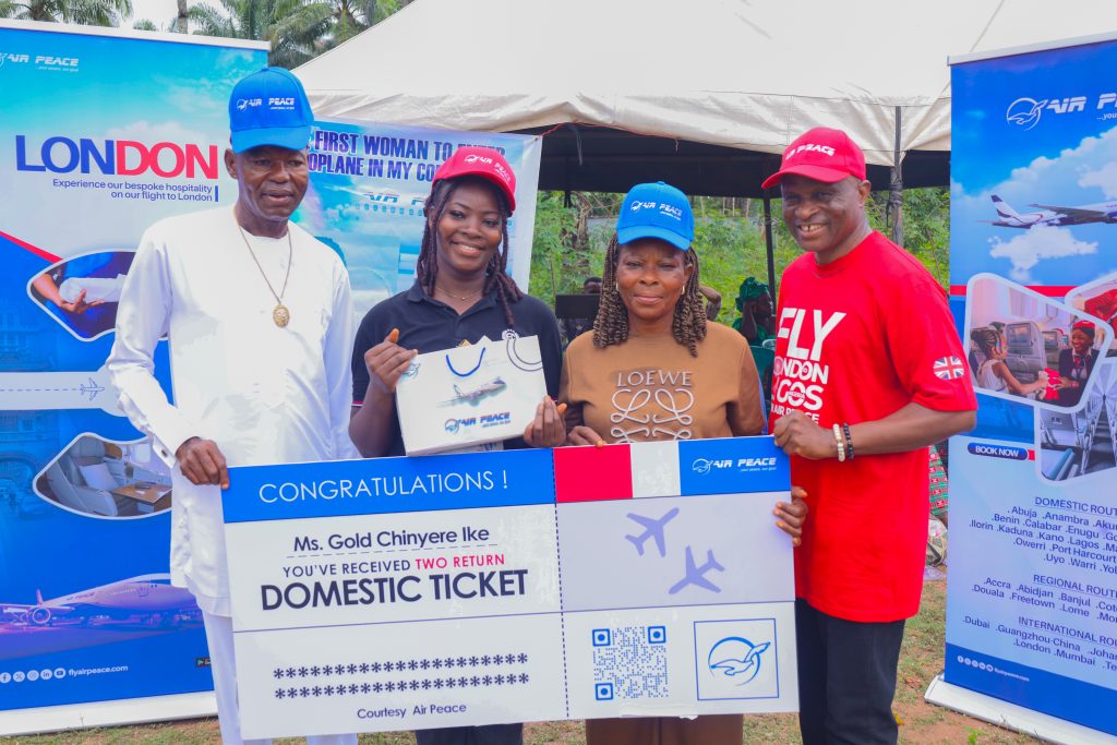 From Skyward Dreams to Soaring Realities: Air Peace Celebrates Ike Gold and Her Community’s Historic Milestone

In a show of warmth, connection, and community pride, West Africa’s largest airline, Air Peace, journeyed deep into the heart of Abia State to honour Ms. Ike Gold Chinyere—the first lady from Umuerim Umukparo in Mbala, Umunneochi LGA, to fly by air, and with Air Peace.

A graduate of Nursing Science from Abia State University and an entrepreneurial farmer, Ms. Ike Gold captured hearts across Nigeria when she took to social media in late March 2025 to chronicle her very first flight experience. Her heartfelt post, brimming with wonder and unfiltered awe, quickly went viral, drawing attention to her humble background and the profound significance of a moment many take for granted.

She spoke of excitement mixed with nerves, and the supportive role her father played—guiding her through the airport, watching her board, and cheering from afar. “When we were on air, I could see the sky differently,” she recalled, eyes still wide with the memory. “Down here, we look up to the sky. But when you’re flying, it’s almost like the sky is beneath you. I couldn’t stop thinking about how such a heavy plane could stay up there.”

This moment, years in the making, had its roots in childhood whimsy. Ike fondly remembered walking with her father and seeing aircraft streak the sky above their community. “I used to say they were throwing down gifts like in Christmas stories,” she laughed. It was a fantasy that bloomed into reality—one that earned a celebration not just for her, but for an entire community.

In response to the massive traction and heartfelt recognition her post on social media had garnered, Air Peace assembled a delegation and journeyed to Umuerim Umukparo. The team was met with a jubilant welcome—drums beating, the Egede dance troupe in full display, and townspeople flooding the community roads in awe and gratitude. For Ike, it was surreal. For her family, it was history. “I didn’t know what to expect,” she said with emotion. “That you people came to my village just because of me... I’m grateful. The community is so happy.”

 The visit was more than symbolic. During their interaction, the Air Peace delegation surprised Ms. Ike with two complimentary return Economy tickets to any domestic destination of her choice, along with branded souvenirs. Visibly stunned, she expressed heartfelt thanks to the airline and its Chairman, Dr. Allen Onyema. “I never expected this,” she said, smiling through tears. “Air Peace is the biggest, not just in Africa, but worldwide.”

In a heartwarming extension of generosity, Air Peace also announced an additional gift: six complimentary domestic return tickets to six women selected from Ike Gold’s local community. The gesture, aimed at empowering more women to experience air travel for the first time, resonated deeply with the people of Umuerim Umukparo. It was a powerful moment of inclusion and encouragement—proof that one person’s milestone can open doors for many. When asked where she would like to explore next, Ike didn’t hesitate—Lagos again, and Abuja, a city she has long dreamt of. “I’ve never been there before,” she said, eyes gleaming with the same excitement that made her story go viral in the first place.

Her father, shared his pride and joy. “I always loved Air Peace, and when it was time for my daughter to travel, I insisted she fly with them,” he explained. Her mother, equally moved, extended her gratitude. “For you to come here, to honour our daughter—it means so much. We thank Dr. Onyema and we thank God for journey mercies.”

In his message, Dr. Allen Onyema noted that “Ms. Gold Chinyere Ike’s journey represents exactly why we do what we do. Air Peace was founded not only to provide safe and affordable air travel, but to make flying accessible to everyday Nigerians—women, men, young people—regardless of their background,” adding “we believe that when people move, dreams move with them.

Ms. Ike’s story is more than a viral moment—it’s a portrait of progress, of dreams that take off despite the odds. In amplifying her voice and investing in her community, Air Peace continues to champion stories that matter. This campaign, quietly nestled within the airline’s extensive CSR framework, reaffirms its commitment to inclusion, community impact, and lifting ordinary lives in extraordinary ways. For Air Peace, flying is not just about where you’re going—it’s about who you become when you finally take off